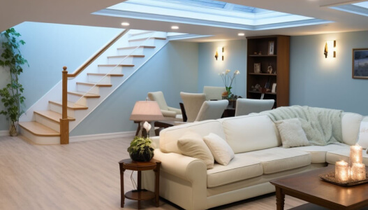 element home solutions modern living room with a white couch wooden staircase and ambient lighting