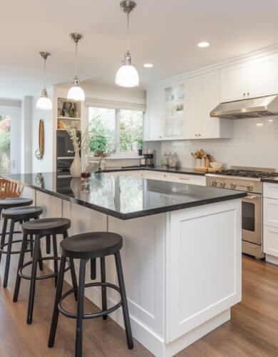 element home solutions tidy kitchen adorned with white cabinets and contrasting black countertops