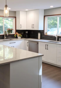 element home solutions tidy kitchen with sleek white cabinetry and warm wood floors